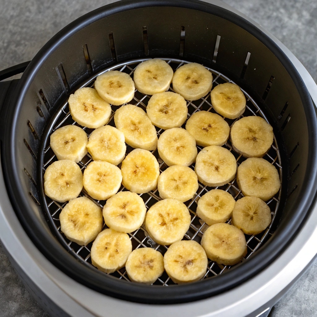 Banana Chips in Air Fryer: Crispy, Healthy Snacking Made Easy 9 Banana chips arranged in air fryer